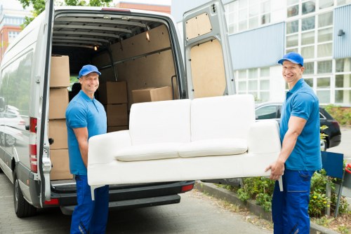 Removal truck and packed moving boxes representing a transparent quote process in Edgware