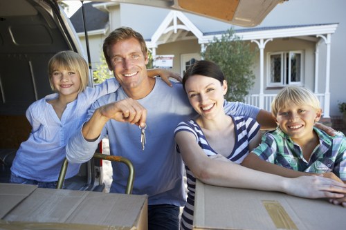 Trained movers handling boxes carefully as part of an insured removals service