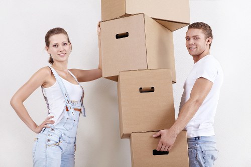 Moving team assessing furniture volume for load-based pricing in Edgware property move