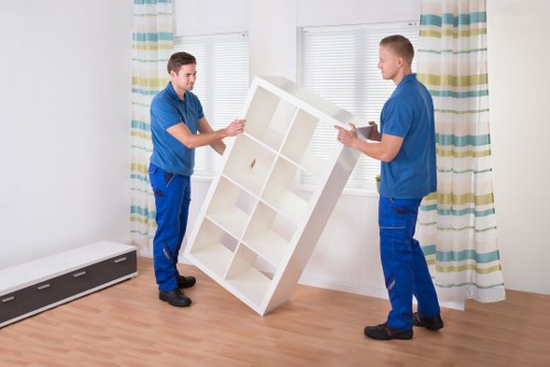 Professional furniture removal service loading a wardrobe